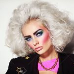 Portrait of young beautiful platinum blond woman with bold eyebrows and 80s  style makeup Stock Photo